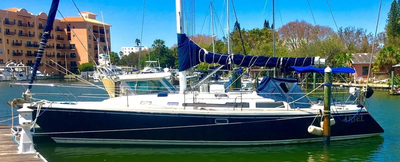 Slide: The Image of 1992 Catalina 42 MK 1 sailboat docked in a sunny marina setting. - 21