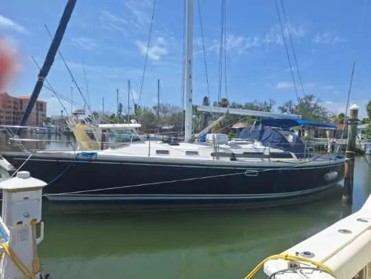 Slide: The Image of 1992 Catalina 42 MK 1 sailboat docked in a marina under a clear blue sky. - 27