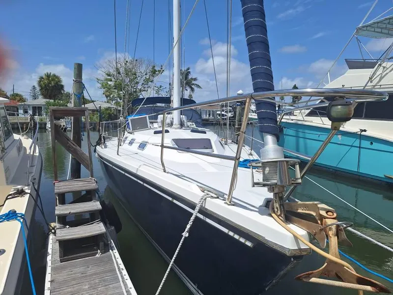 Slide: The Image of 1992 Catalina 42 MK 1 sailboat docked in a sunny marina. - 28