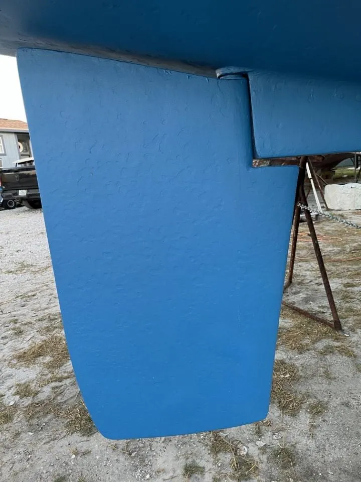 Slide: The Image of Blue rudder of a 1992 Catalina 42 MK 1 sailboat on dry land. - 6