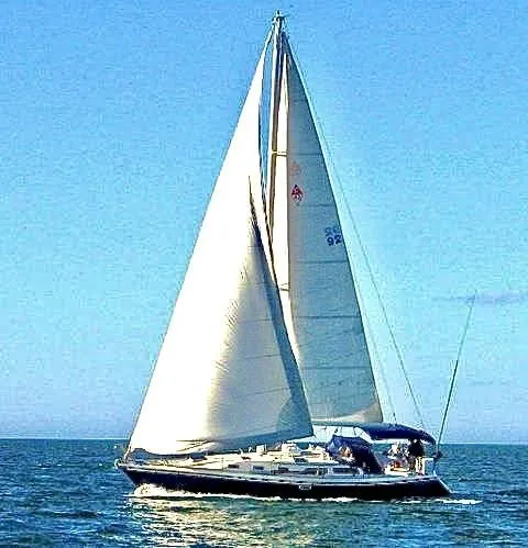 Slide: The Image of 1992 Catalina 42 MK 1 sailboat cruising on open water under clear blue skies. - 7
