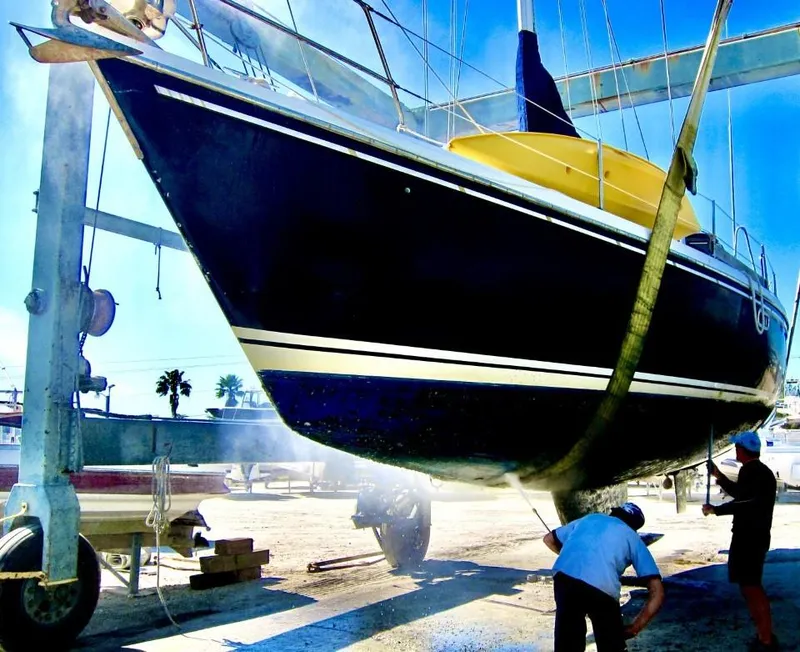 Slide: The Image of 1992 Catalina 42 MK 1 sailboat being lifted for maintenance at a marina. - 9
