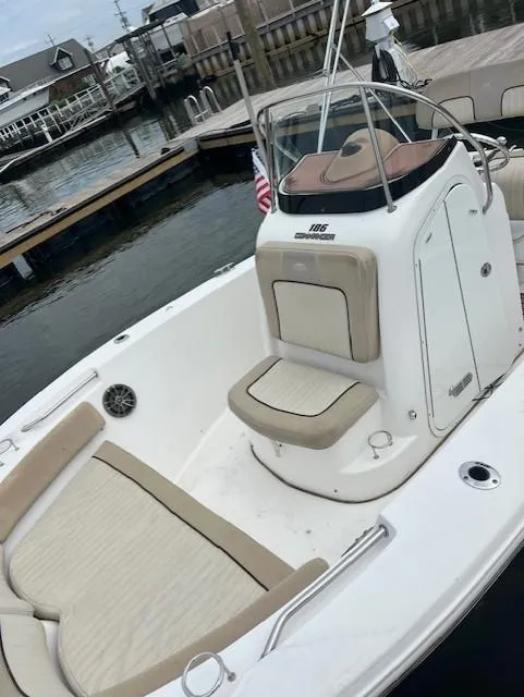Slide: The Image of 2016 Sea Fox 186 Commander boat docked, featuring beige seating and sleek design. - 8