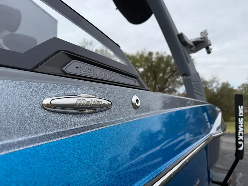 Slide: The Image of 2020 Malibu Wakesetter 23 MXZ boat, close-up of sleek blue exterior design. - 11
