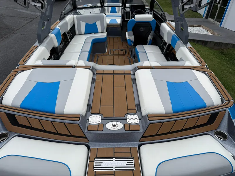 Slide: The Image of 2020 Malibu Wakesetter 23 MXZ interior with blue and white seating, teak flooring. - 13