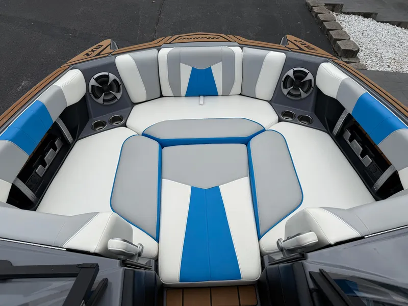 Slide: The Image of 2020 Malibu Wakesetter 23 MXZ boat interior with blue and white seating. - 16