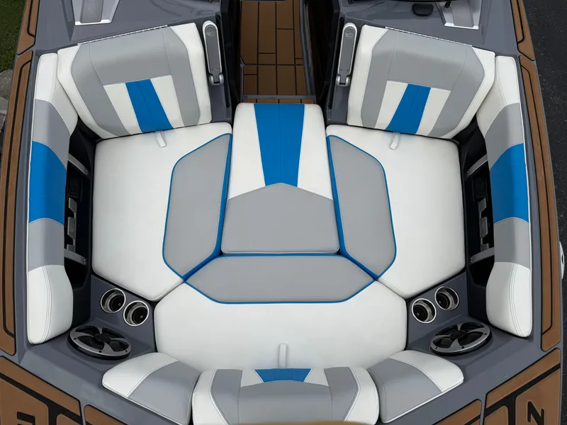 Slide: The Image of 2020 Malibu Wakesetter 23 MXZ boat interior with blue and gray seating. - 17