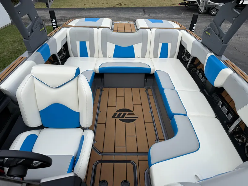 Slide: The Image of 2020 Malibu Wakesetter 23 MXZ interior with blue and white seating, teak flooring. - 19