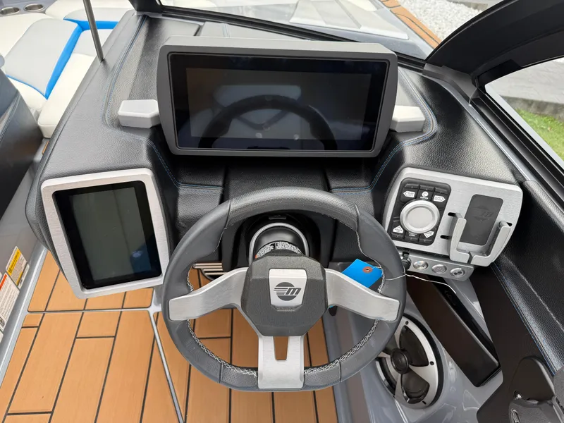 Slide: The Image of 2020 Malibu Wakesetter 23 MXZ dashboard with steering wheel and digital displays. - 24