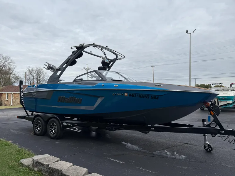 Slide: The Image of 2020 Malibu Wakesetter 23 MXZ boat on trailer, parked outdoors. - 3