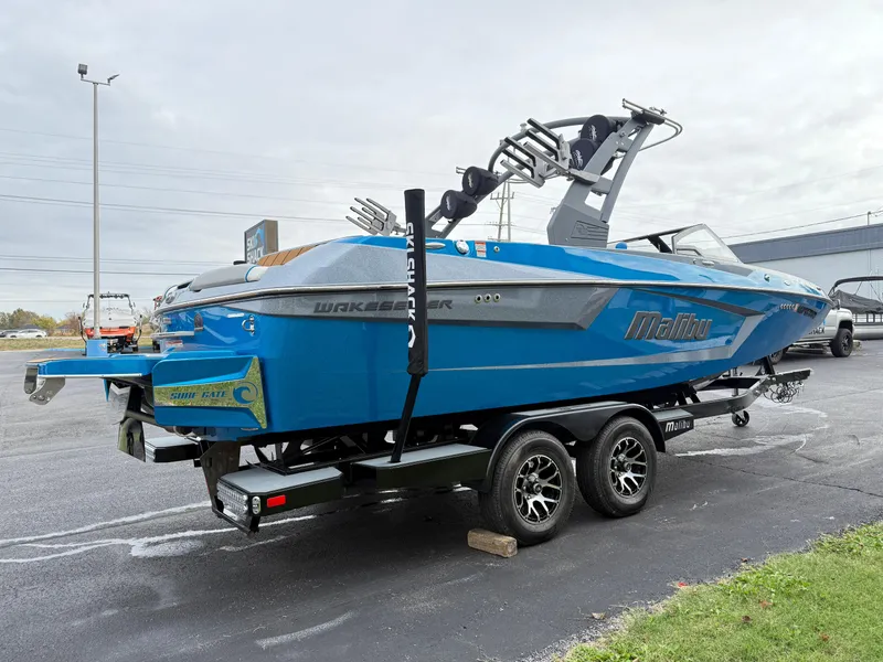 Slide: The Image of 2020 Malibu Wakesetter 23 MXZ boat in vibrant blue on a trailer. - 5