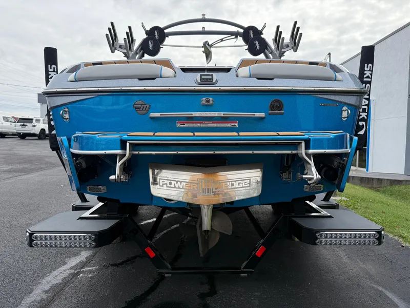 Slide: The Image of 2020 Malibu Wakesetter 23 MXZ boat rear view with Power Wedge feature, parked outdoors. - 6