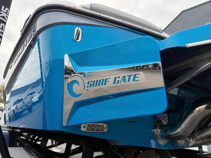Slide: The Image of 2020 Malibu Wakesetter 23 MXZ with Surf Gate technology, blue exterior detail. - 9