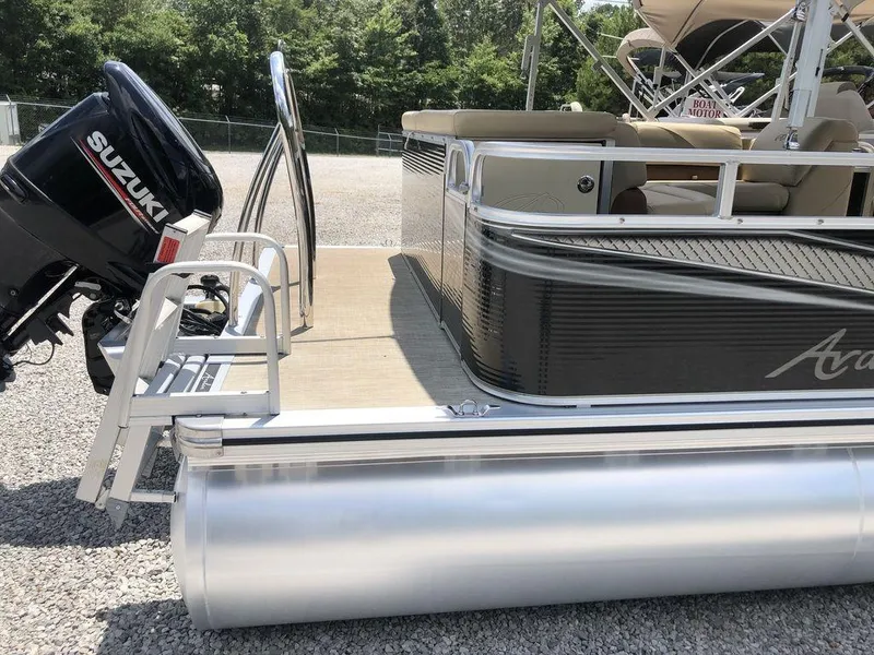 Slide: The Image of 2019 Avalon GS Cruise 23' pontoon boat with Suzuki motor, docked on gravel. - 5