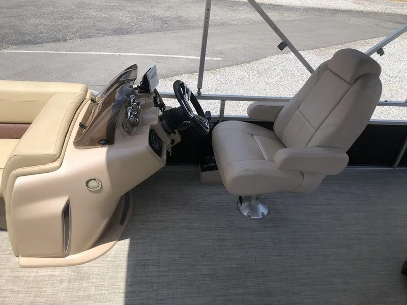 Slide: The Image of 2019 Avalon GS Cruise 23' boat interior with beige captain's chair and steering console. - 6