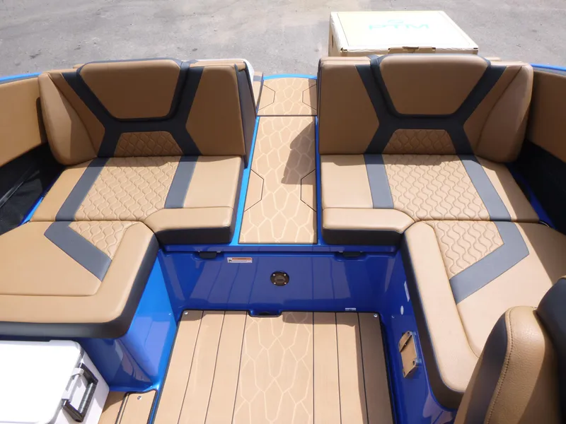Slide: The Image of 2025 Yamaha Boats 222XD interior with tan and blue seating, modern design. - 11