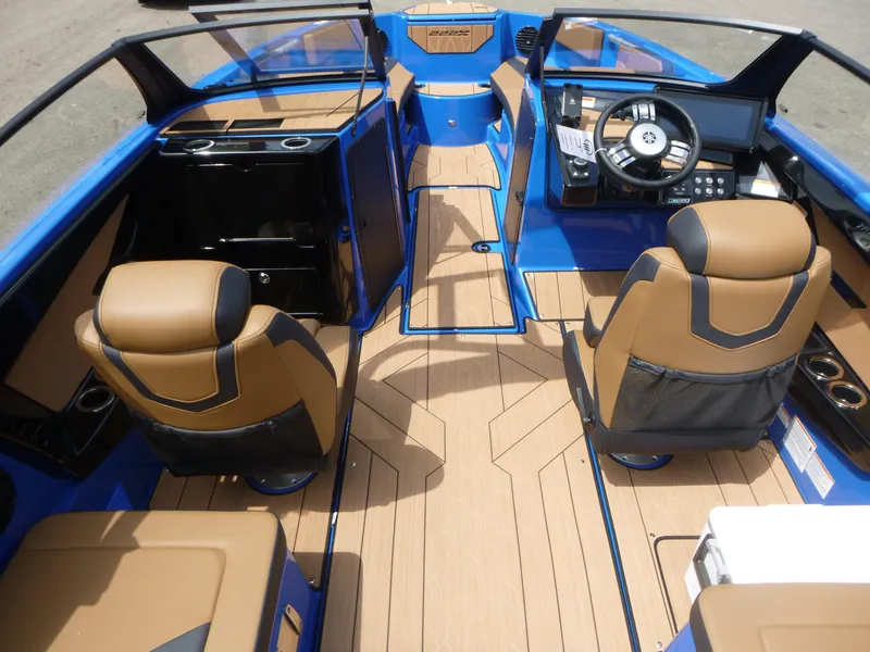 Slide: The Image of 2025 Yamaha Boats 222XD interior with tan seats, modern dashboard, and blue accents. - 5