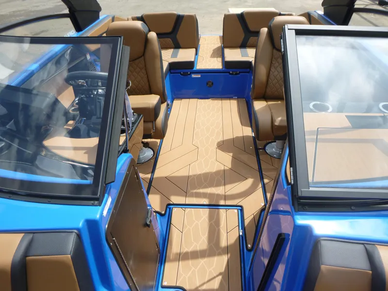 Slide: The Image of 2025 Yamaha Boats 222XD interior with tan seating and blue accents. - 6