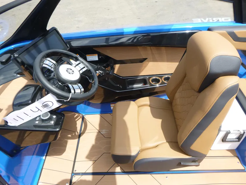 Slide: The Image of 2025 Yamaha Boats 222XD interior with tan seating and modern steering console. - 7