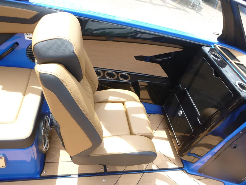 Slide: The Image of 2025 Yamaha Boats 222XD interior with tan seating and sleek black accents. - 9