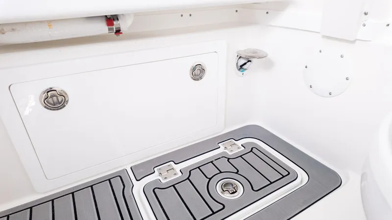 Slide: The Image of Interior view of 2026 Tidewater 302CC boat, featuring storage compartment and non-slip flooring. - 10