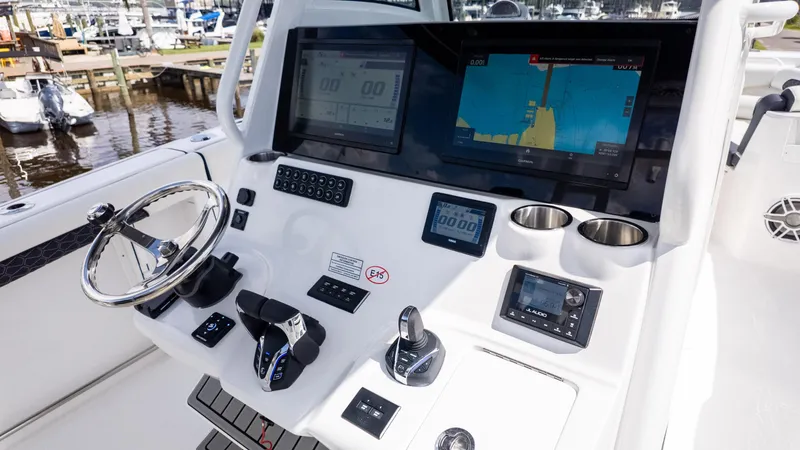 Slide: The Image of 2026 Tidewater 302CC boat interior with white seating and storage compartment. - 13