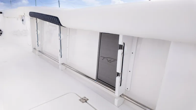 Slide: The Image of 2026 Tidewater 302CC boat interior with steering wheel and fresh water access. - 14