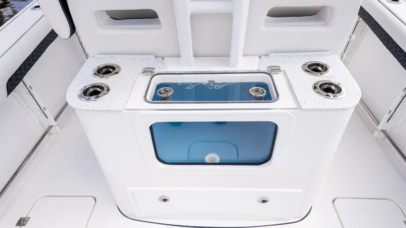 Slide: The Image of 2026 Tidewater 302CC boat interior with cup holders and storage compartment. - 16