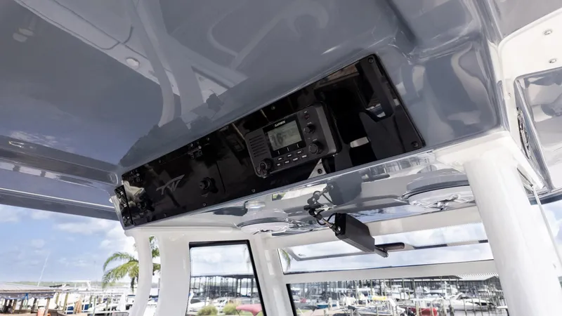 Slide: The Image of Tidewater 302CC 2026 boat console with electronic controls and marina background. - 20