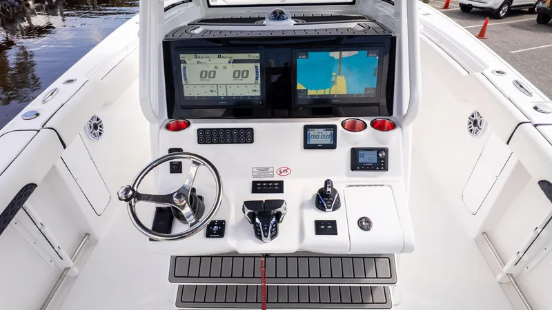 Slide: The Image of Helm of 2026 Tidewater 302CC boat with advanced navigation displays and controls. - 21