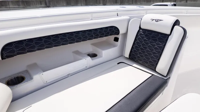 Slide: The Image of 2026 Tidewater 302CC boat interior with stylish black and white seating and cup holders. - 4