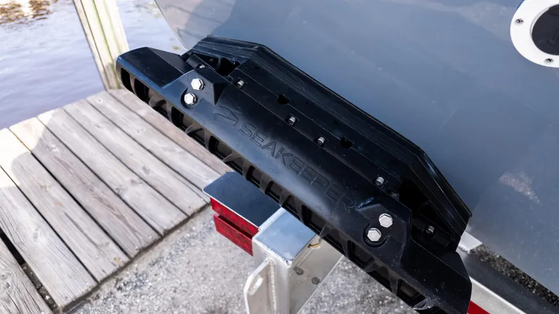 Slide: The Image of 2026 Tidewater 302CC boat with Seakeeper stabilizer, docked on wooden pier. - 7