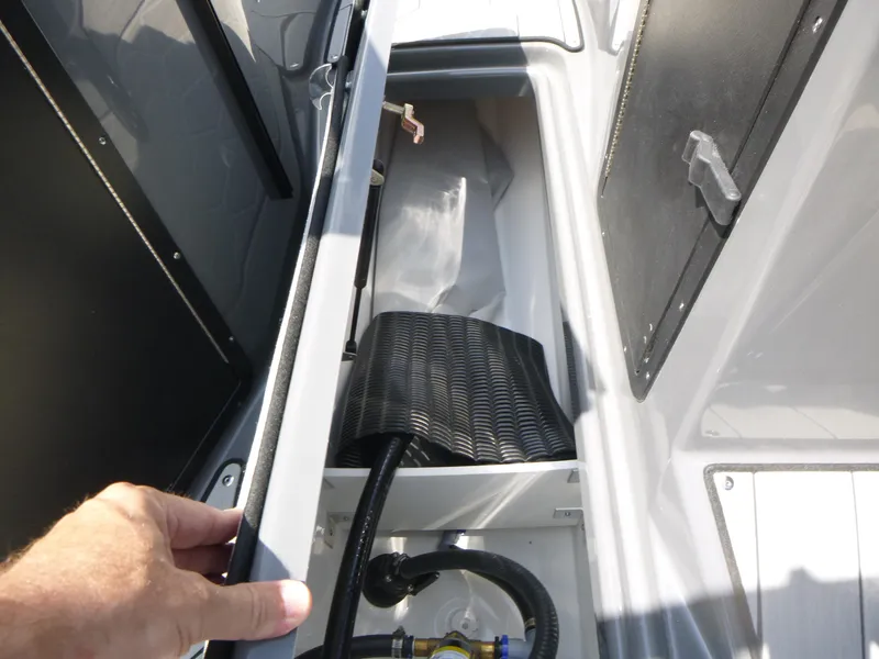 Slide: The Image of 2025 Yamaha Boats 222XD storage compartment with hand opening hatch. - 13