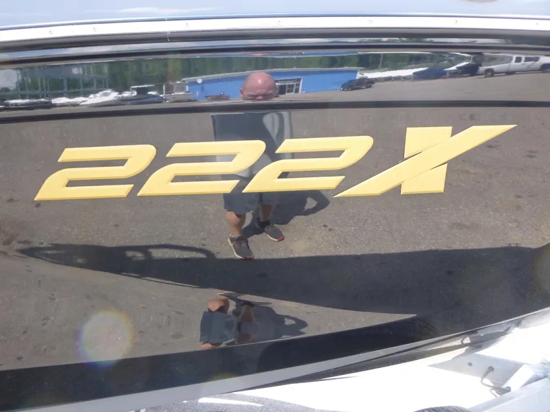 Slide: The Image of 2025 Yamaha Boats 222XD logo on sleek black surface, reflecting surroundings. - 16
