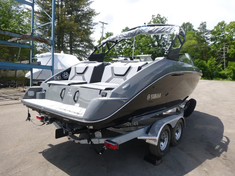 Slide: The Image of 2025 Yamaha Boats 222XD on trailer, sleek design, parked outdoors. - 2