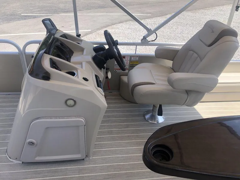 Slide: The Image of 2024 Bennington 20 SF boat interior with captain's chair and steering console. - 8