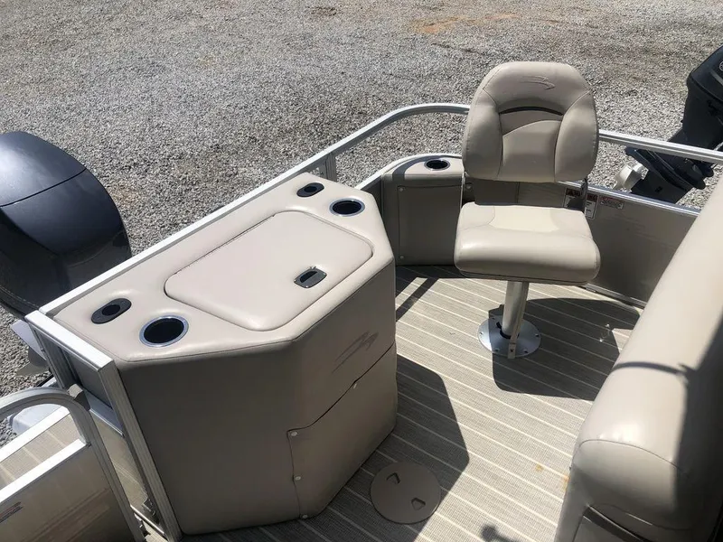 Slide: The Image of 2024 Bennington 20 SF boat interior with beige seating and storage compartments. - 9