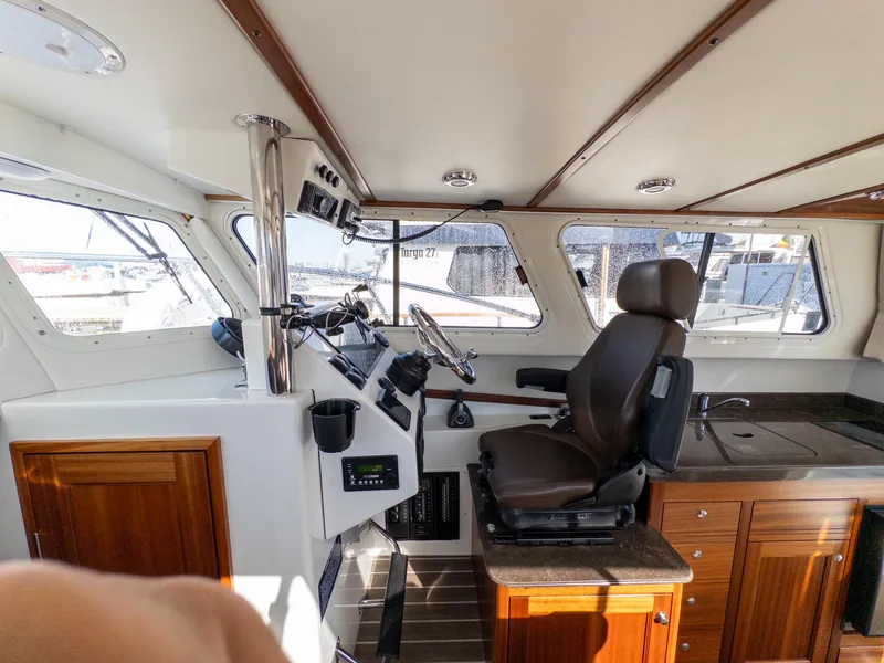 Slide: The Image of Interior of a 2021 Ocean Sport 26/27 boat, featuring helm and seating area. - 20