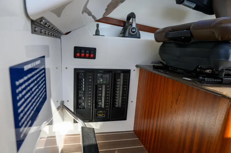 Slide: The Image of Interior of 2021 Ocean Sport 26/27 boat showing control panel and seating area. - 21
