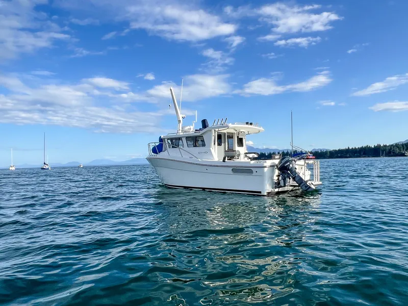 Slide: The Image of 2021 Ocean Sport 26/27 boat on calm water under blue sky. - 8