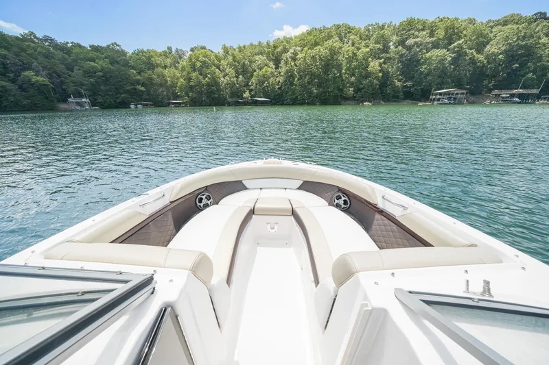 Slide: The Image of 2015 Regal 2700 ES Bowrider on a serene lake with lush green shoreline. - 11