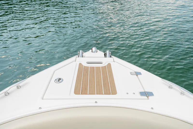 Slide: The Image of Bow of 2015 Regal 2700 ES Bowrider on calm water. - 12