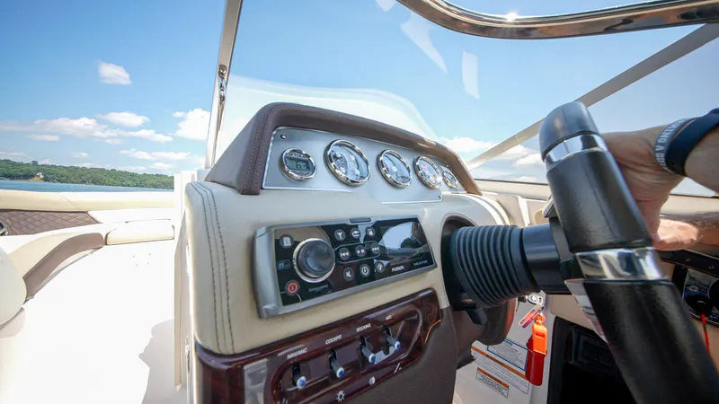 Slide: The Image of 2015 Regal 2700 ES Bowrider dashboard with steering wheel and control panel. - 13