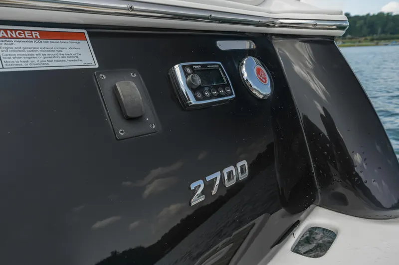 Slide: The Image of 2015 Regal 2700 ES Bowrider boat detail with control panel and warning label. - 18