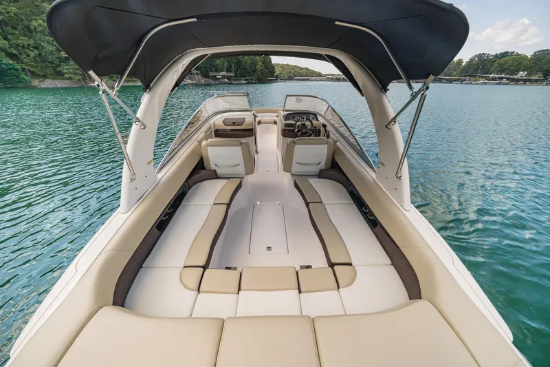 Slide: The Image of 2015 Regal 2700 ES Bowrider boat with spacious seating on a serene lake. - 19