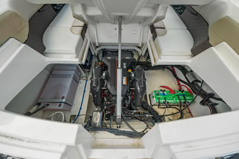 Slide: The Image of 2015 Regal 2700 ES Bowrider engine compartment with batteries and seating area. - 20