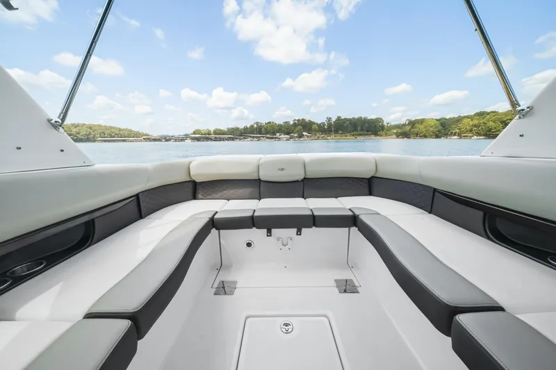 Slide: The Image of 2015 Regal 2700 ES Bowrider interior with spacious seating, overlooking serene lake view. - 8