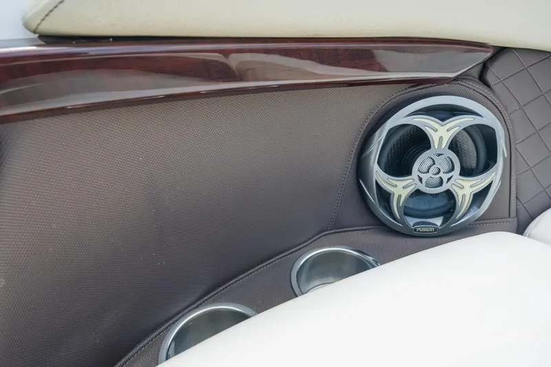 Slide: The Image of Speaker and cup holders in 2015 Regal 2700 ES Bowrider boat interior. - 9