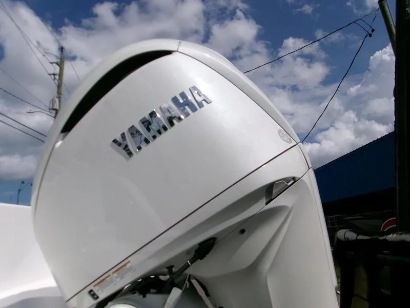 Slide: The Image of Yamaha outboard motor on 2026 Sportsman Open 232 boat under blue sky. - 2