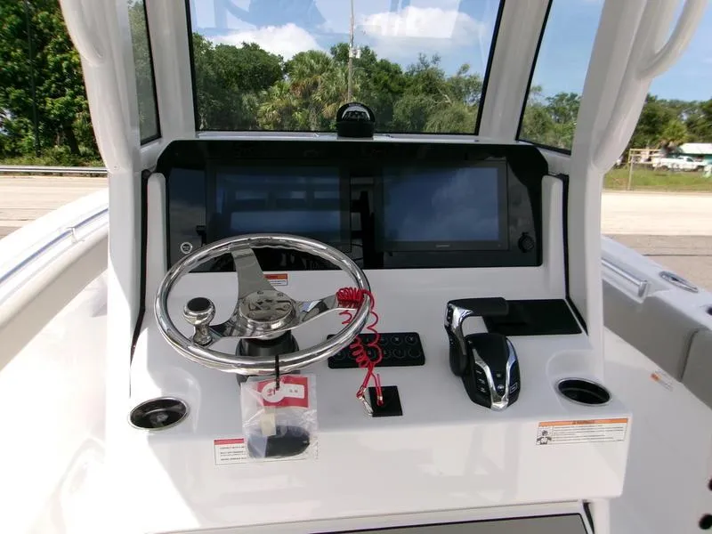 Slide: The Image of 2026 Sportsman Open 232 boat dashboard with steering wheel and control panel. - 7